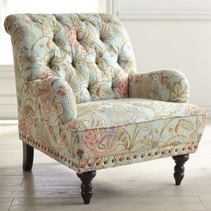 Floral patterned armchair with vintage charm.